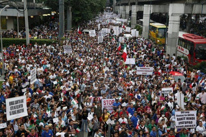Thousands of protesters belonging to the Iglesia ni Cristo (Church of Christ) group march along EDSA highway in Mandaluyong